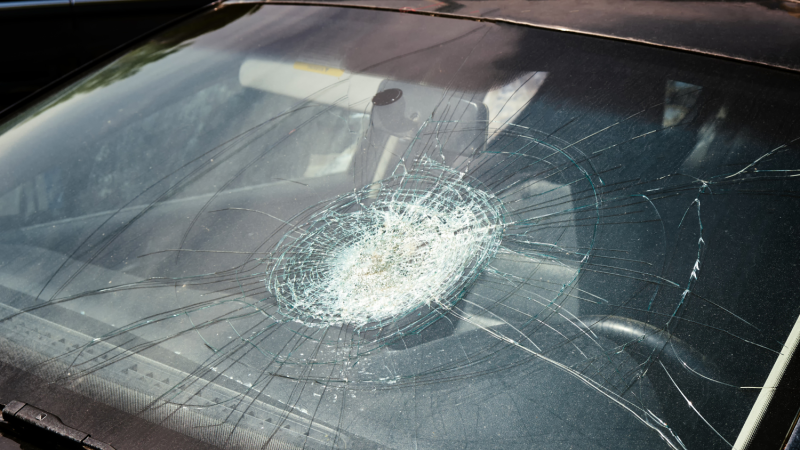Cracked windshield from a car accident in Fort Lauderdale, symbolizing the aftermath of a collision and potential injuries like a concussion.