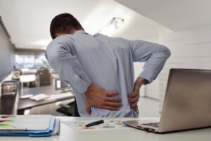 person holding their back in pain