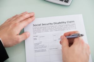 person filling out disability claim form