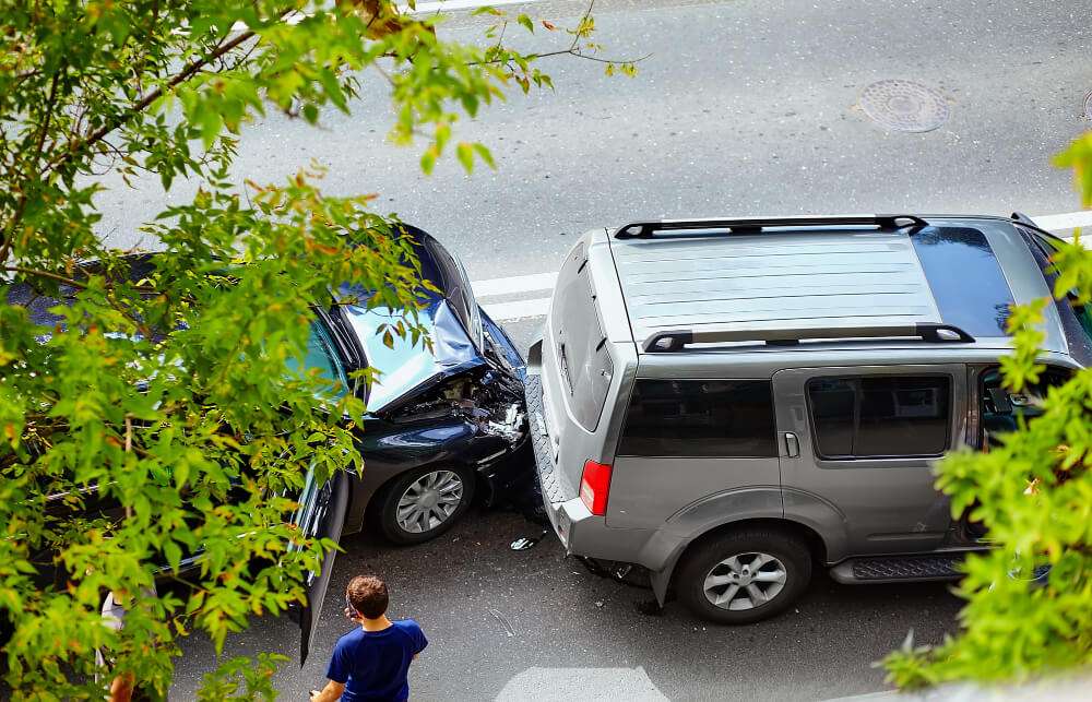 Two cars involved in a rear-end collision on a street