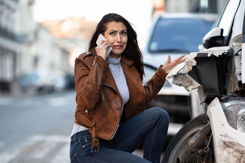Woman on phone after car accident