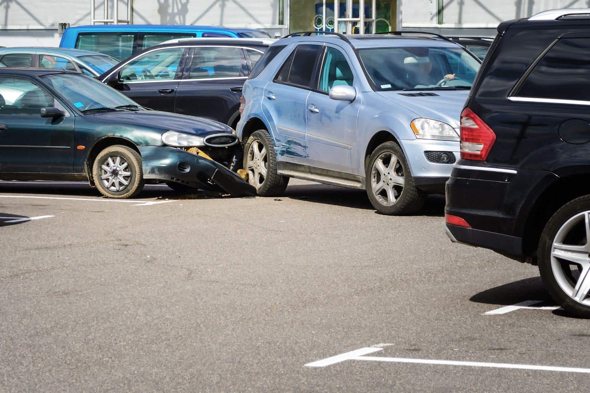 a couple of cars that are in a parking lot after having crashed