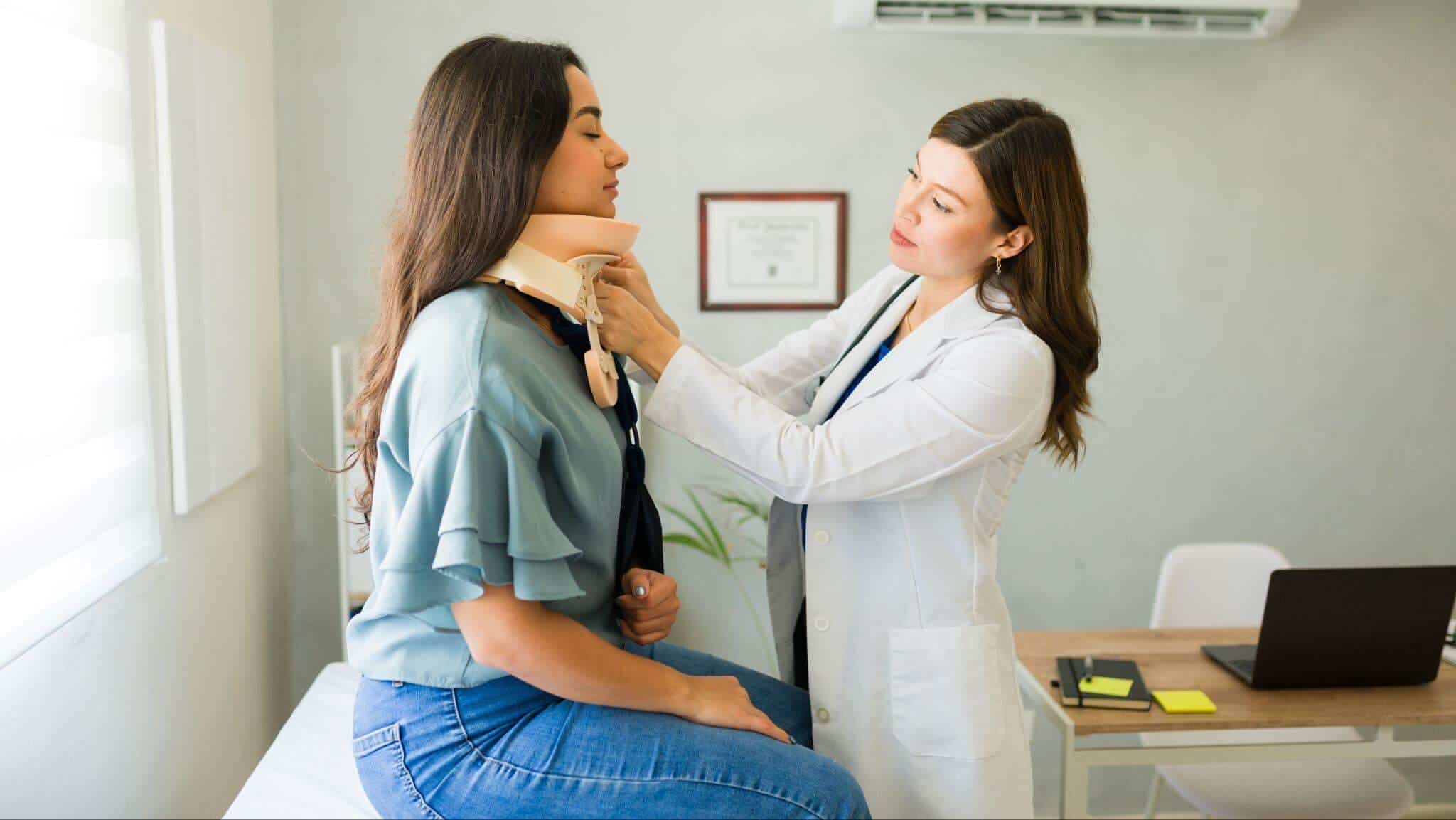 a woman getting a cervical collar adjusted by a doctor
