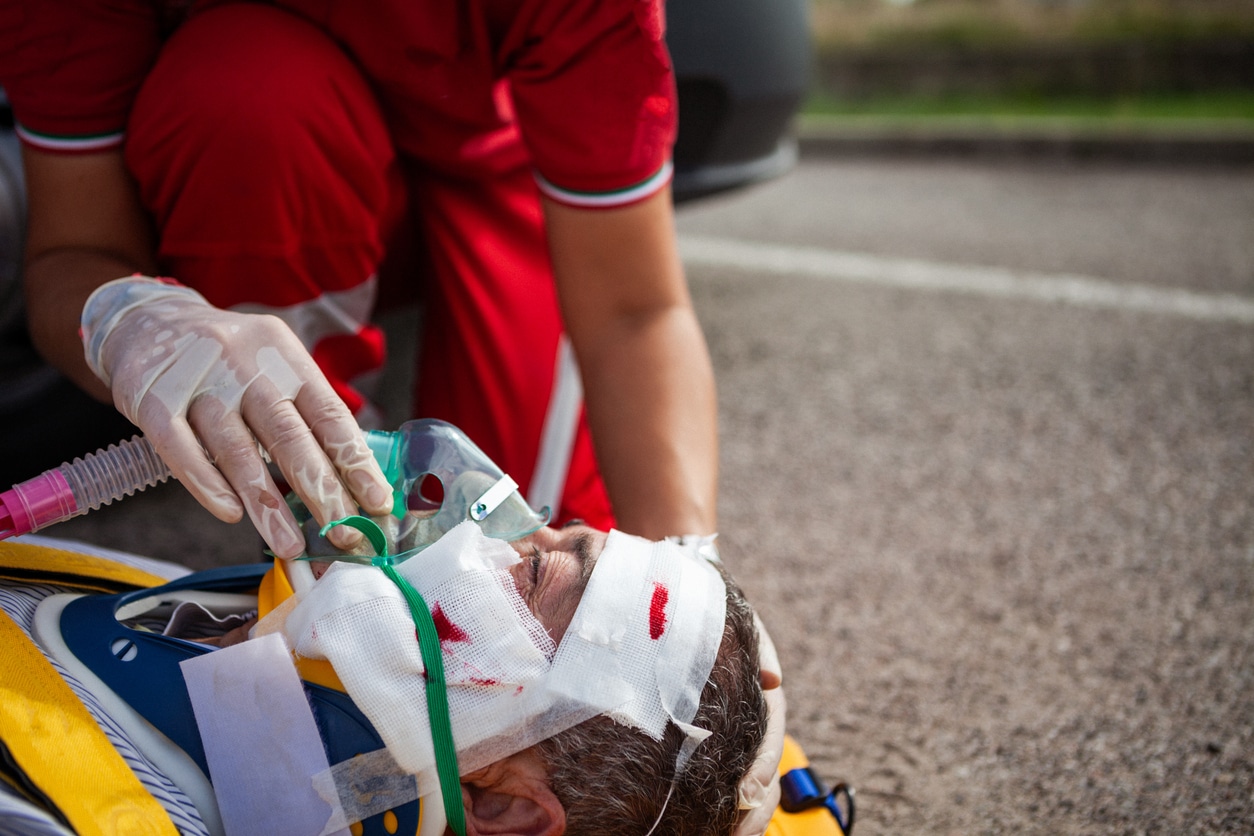 Paramedic Providing Oxygen to Injured Man at Accident Scene