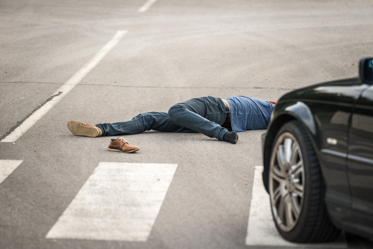 Male person got hit by a car, focus on shoe